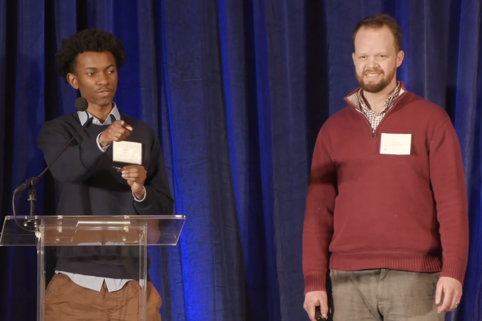 Two men talking on stage