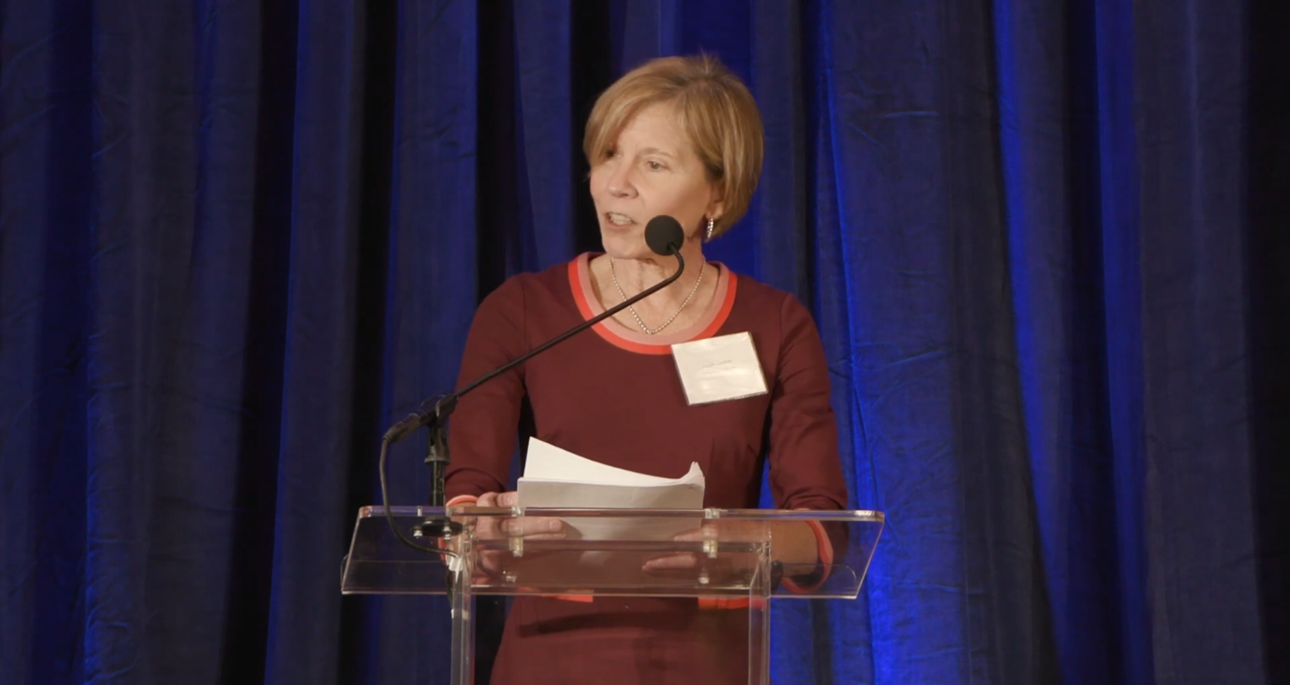 Woman in red blouse on stage