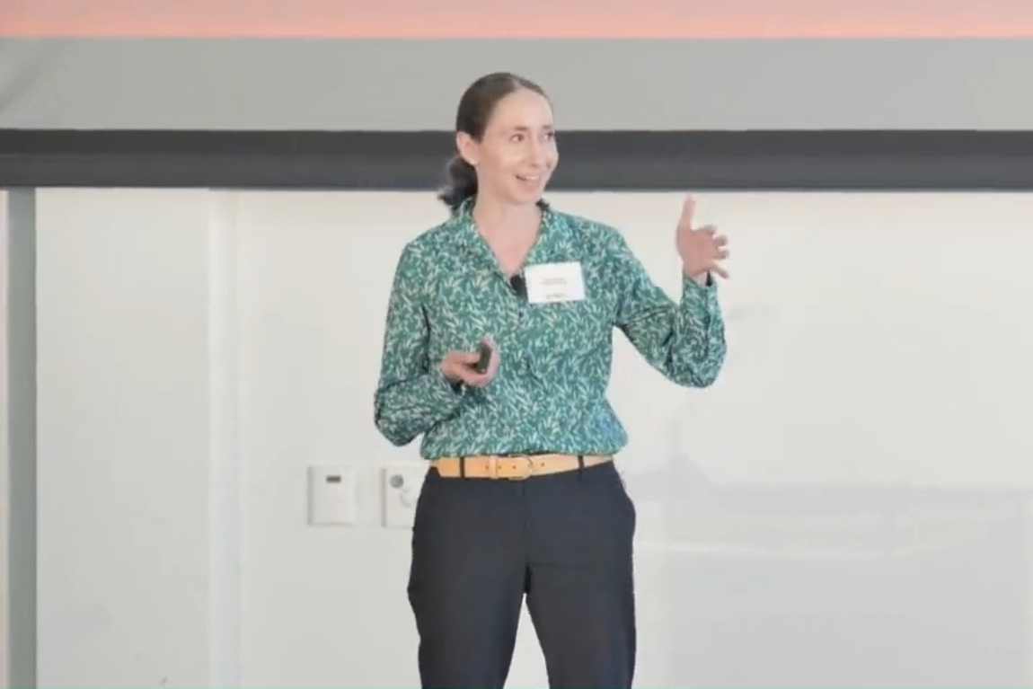 Woman in green top on stage