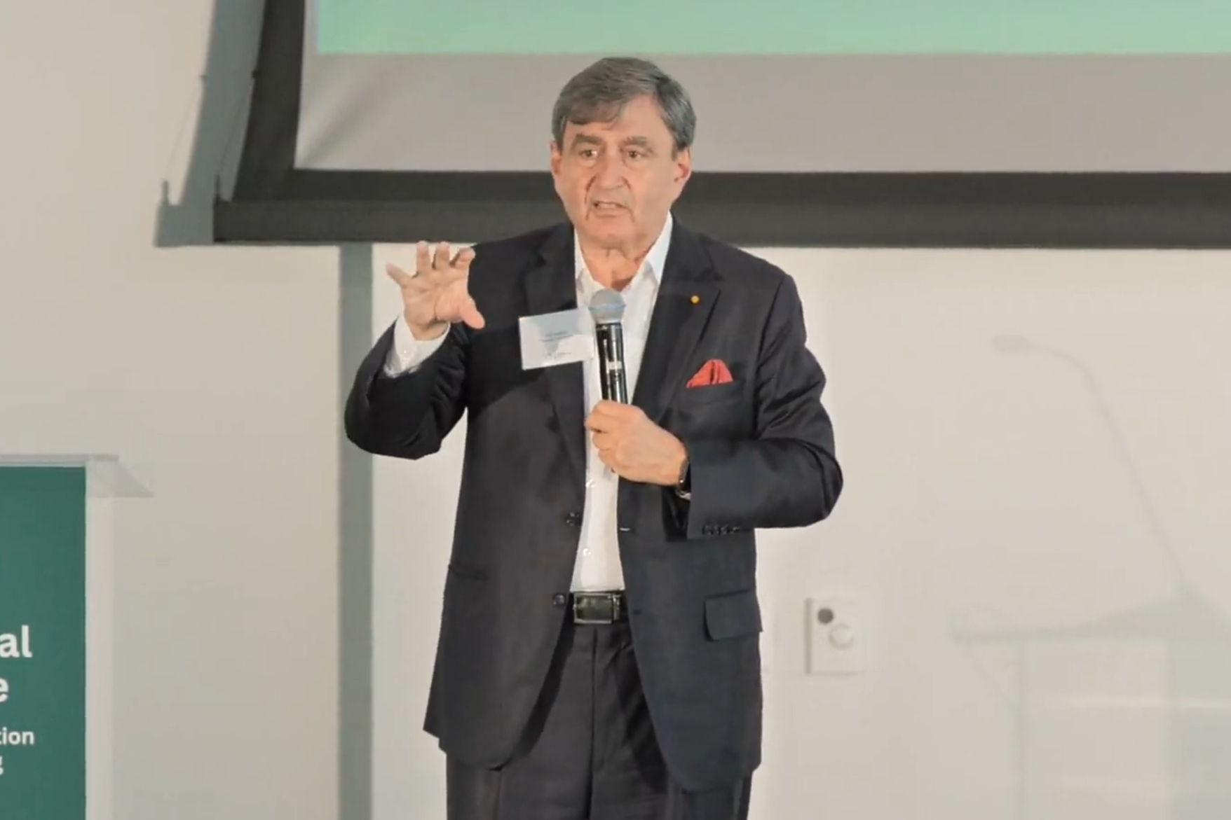 Man in suit talking on stage