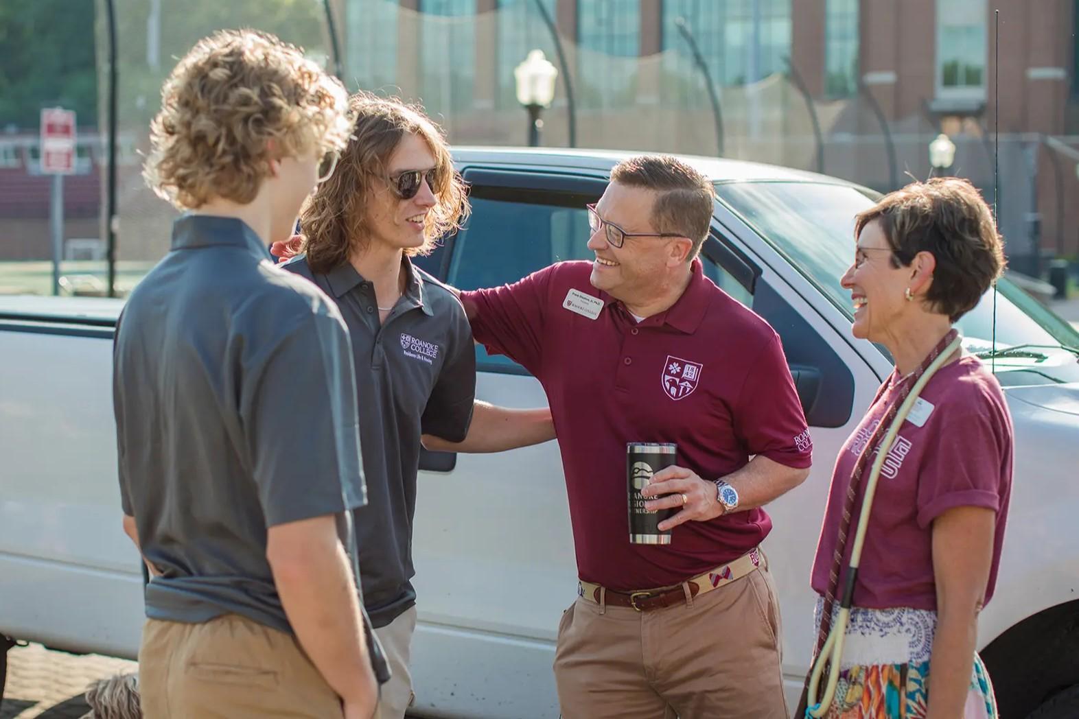 Four people talking and laughing